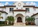 Mediterranean-style home with detailed stone facade and arched entryway at 1389 Tangier Way, Sarasota, FL 34239