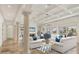 Spacious living room with high ceilings, fireplace, and water views at 1389 Tangier Way, Sarasota, FL 34239