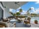 Relaxing poolside patio with comfortable seating and water views at 1389 Tangier Way, Sarasota, FL 34239