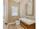 Modern powder room with floating vanity and designer wallpaper at 1389 Tangier Way, Sarasota, FL 34239