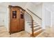 Elegant staircase with a curved design and dark wood finishes at 1389 Tangier Way, Sarasota, FL 34239