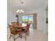 Bright dining room with wooden table and chairs, and view to backyard at 15184 Aldama Cir, Port Charlotte, FL 33981