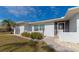 Front entrance with walkway, landscaping, and screened door at 15184 Aldama Cir, Port Charlotte, FL 33981