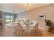 Bright dining area with glass table and white chairs, adjacent to living room at 15910 Clear Skies Pl, Bradenton, FL 34211