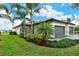 Well-manicured landscaping, two-car garage, and attractive exterior at 15910 Clear Skies Pl, Bradenton, FL 34211