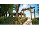 Private beach access with wooden walkway and archway at 1603 Gulf N Dr # 27, Bradenton Beach, FL 34217