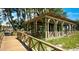 Wooden gazebo near beach with walkway, offering shade and views at 1603 Gulf N Dr # 27, Bradenton Beach, FL 34217