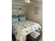 Bedroom with coastal bedding, a ceiling fan, and beach-themed decor at 1603 Gulf N Dr # 27, Bradenton Beach, FL 34217