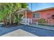Pink cottage with white trim, front porch, and small yard at 1603 Gulf N Dr # 27, Bradenton Beach, FL 34217