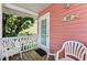 Quaint cottage front porch with seating and direct access at 1603 Gulf N Dr # 27, Bradenton Beach, FL 34217