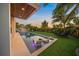 Modern backyard oasis with a rectangular pool and lounge chairs at 1707 Palma Sola Blvd, Bradenton, FL 34209