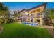 Stunning two-story home, pool, and lush lawn at dusk at 1707 Palma Sola Blvd, Bradenton, FL 34209