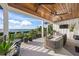 Relaxing balcony with water views, outdoor seating, and ceiling fan at 1707 Palma Sola Blvd, Bradenton, FL 34209