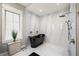 Spa-like bathroom with black tub and marble shower surround at 1707 Palma Sola Blvd, Bradenton, FL 34209