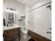 Bathroom with a soaking tub, wood vanity, and patterned tile floor at 1707 Palma Sola Blvd, Bradenton, FL 34209