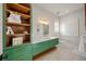 ' bathroom with green vanity and modern fixtures at 1707 Palma Sola Blvd, Bradenton, FL 34209