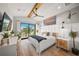 Main bedroom with water views, wood beam ceiling and modern decor at 1707 Palma Sola Blvd, Bradenton, FL 34209