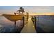 Private lighted dock with boat at sunset at 1707 Palma Sola Blvd, Bradenton, FL 34209