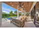 Covered patio with wooden ceiling, comfortable seating, and pool views at 1707 Palma Sola Blvd, Bradenton, FL 34209