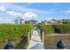 Private dock with views of neighboring waterfront homes at 1707 Palma Sola Blvd, Bradenton, FL 34209