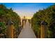 Lighted walkway to private dock at sunset at 1707 Palma Sola Blvd, Bradenton, FL 34209