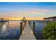Dock view at sunset with neighboring docks at 1707 Palma Sola Blvd, Bradenton, FL 34209