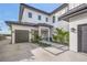 Modern home exterior with two-car garage and landscaping at 1707 Palma Sola Blvd, Bradenton, FL 34209