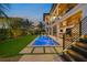 Back exterior of the house with a lighted pool and patio at 1707 Palma Sola Blvd, Bradenton, FL 34209