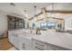 Modern kitchen with farmhouse sink, white cabinets and stunning water views at 1707 Palma Sola Blvd, Bradenton, FL 34209