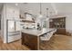 Modern kitchen features white cabinetry, a large island, and stainless steel appliances at 1707 Palma Sola Blvd, Bradenton, FL 34209