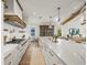 Bright kitchen with white cabinets, marble countertops, and a long island at 1707 Palma Sola Blvd, Bradenton, FL 34209