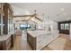 Open concept kitchen with island, white cabinets, and views to living room and water at 1707 Palma Sola Blvd, Bradenton, FL 34209