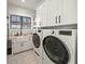 Laundry room with white cabinets, a farmhouse sink, and new appliances at 1707 Palma Sola Blvd, Bradenton, FL 34209