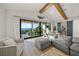 Living area with water views, gray sectional sofa, and hardwood floors at 1707 Palma Sola Blvd, Bradenton, FL 34209