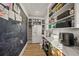 Walk-in pantry with chalkboard wall, ample shelving and counter space at 1707 Palma Sola Blvd, Bradenton, FL 34209
