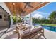 Relaxing patio with covered seating and pool view at 1707 Palma Sola Blvd, Bradenton, FL 34209