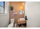 Stylish powder room with wood-paneled walls and floating vanity at 1707 Palma Sola Blvd, Bradenton, FL 34209