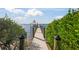 Wooden walkway to a private dock with a boat lift at 1707 Palma Sola Blvd, Bradenton, FL 34209