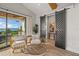 Relaxing sitting area with wicker chairs and sliding doors to balcony at 1707 Palma Sola Blvd, Bradenton, FL 34209