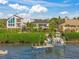 Boat dock and waterfront view of luxury home at 1707 Palma Sola Blvd, Bradenton, FL 34209