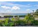 Stunning view of the water with lush landscaping at 1707 Palma Sola Blvd, Bradenton, FL 34209