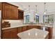 Open kitchen with island, custom cabinetry, and breakfast bar at 17109 1St E Dr, Bradenton, FL 34212