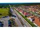 Aerial view of new homes with tile roofs in a new community at 17322 Holly Well Ave, Wimauma, FL 33598