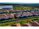 Aerial view of new homes with tile roofs in a new community at 17322 Holly Well Ave, Wimauma, FL 33598
