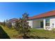 Landscaped backyard with young trees and patio at 17322 Holly Well Ave, Wimauma, FL 33598