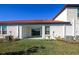 Home exterior showcasing a private patio and grassy area at 17322 Holly Well Ave, Wimauma, FL 33598