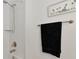Simple bathroom with shower and a black towel at 17322 Holly Well Ave, Wimauma, FL 33598