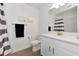 Clean bathroom with white vanity, striped shower curtain, and toilet at 17322 Holly Well Ave, Wimauma, FL 33598