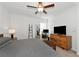 Spacious bedroom with king bed, ceiling fan, and home office area at 17322 Holly Well Ave, Wimauma, FL 33598