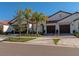 Two-story home with two-car garage and landscaping at 17322 Holly Well Ave, Wimauma, FL 33598